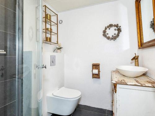 a bathroom with a toilet and a sink at Idyllic Beach Retreat in Albaek in Ålbæk