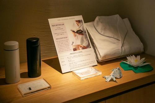 a table with a book and other items on it at THE GENERAL KYOTO Shijou Shinmachi in Kyoto