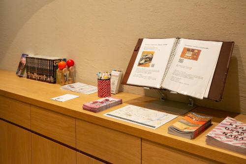 a desk with a computer on top of a desk at THE GENERAL KYOTO Shijou Shinmachi in Kyoto