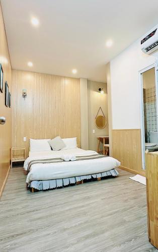 a large bedroom with two beds in it at Sele House in Ha Tien