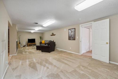 an empty living room with a couch and a television at Country Club View in Marion, Iowa in Marion