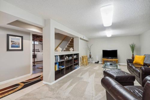 a living room with a couch and a tv at Country Club View in Marion, Iowa in Marion