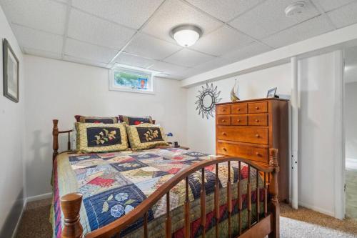 a bedroom with a bed and a dresser at Country Club View in Marion, Iowa in Marion