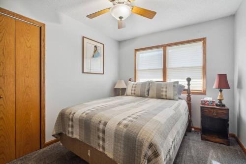 a bedroom with a bed and a ceiling fan at Country Club View in Marion, Iowa in Marion