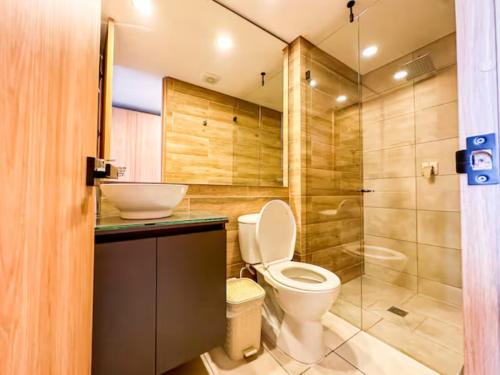 a bathroom with a toilet and a shower at Skyline Suites - Elegant Living with Coworking & Scenic Views in Bogotá