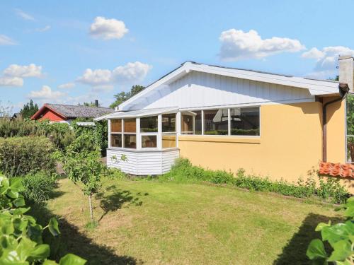 a yellow house with a garden in front of it at 4 person holiday home in Ålbæk-By Traum in Ålbæk