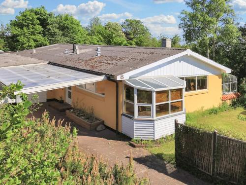 a yellow house with a lot of windows at 4 person holiday home in Ålbæk-By Traum in Ålbæk