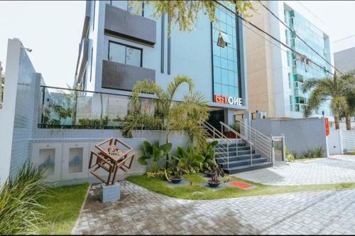 a building with a sign in front of it at Flat a 50m Praia Caribessa - Get One in João Pessoa