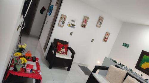 a living room with a table and a chair at Vivienda Turistica Angel 2 in Salento