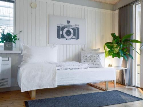 a bedroom with a bed with a camera on the wall at 5 person holiday home in Føllenslev-By Traum in Føllenslev