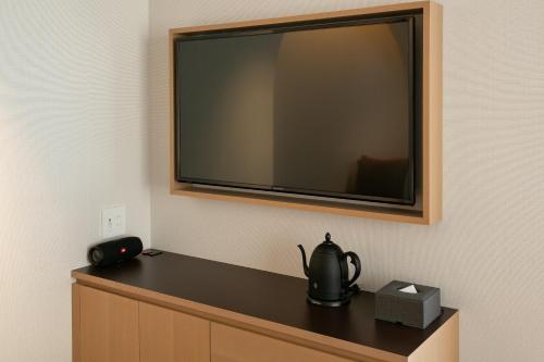 a flat screen tv hanging on a wall at THE GENERAL KYOTO Shijou Shinmachi in Kyoto