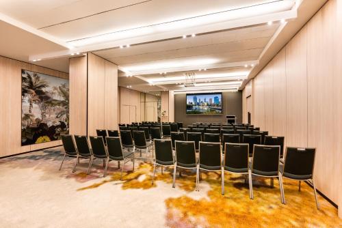 a conference room with chairs and a projection screen at Pan Pacific Perth in Perth