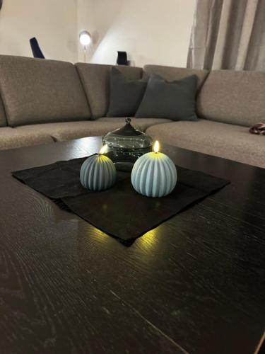 a table with three candles on top of a table at Gammelgårdvegen 31 in Tromsø