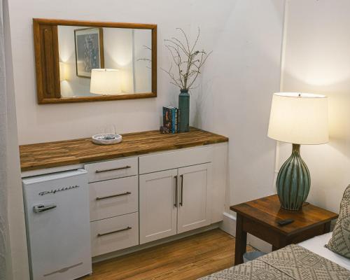 a room with a counter with a mirror and a table at Warner Hotel in Bisbee