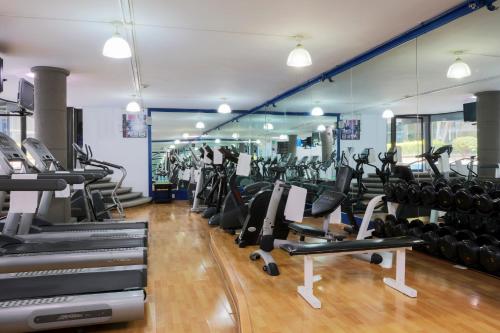 a gym with treadmills and elliptical machines at Krystal Satelite Maria Barbara in Mexico City