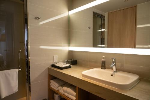 a bathroom with a sink and a mirror at THE GENERAL KYOTO Shijou Shinmachi in Kyoto