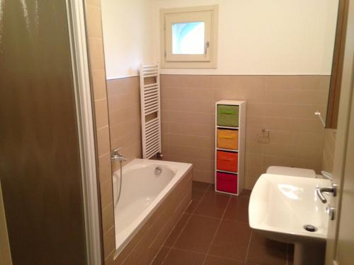 a bathroom with a bath tub and a sink at La Supernova in Bergamo