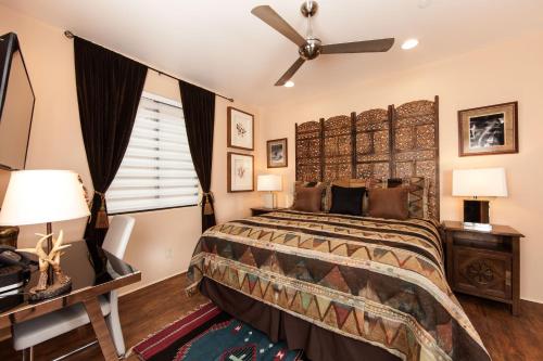 a bedroom with a bed and a ceiling fan at A Sunset Chateau in Sedona