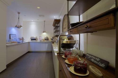 a kitchen with a counter with plates of food on it at FourSide Plaza Hotel Trier, Trademark Collection by Wyndham in Trier