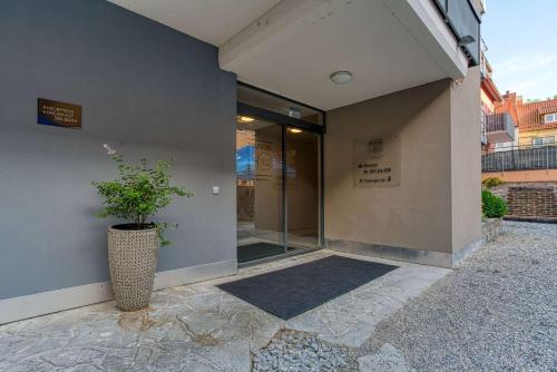 a building with a potted plant in front of it at Centro Hotel Stern Ulm City, Trademark Collection by Wyndham in Ulm