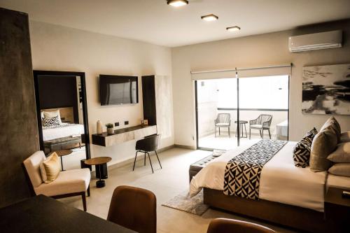 a hotel room with a bed and a balcony at Esplendor by Wyndham San Luis Potosi in San Luis Potosí