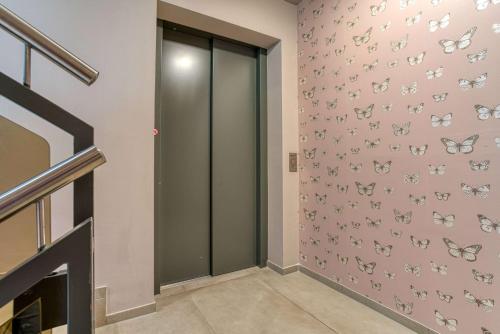 a hallway with pink butterflies on the wall at Centro Hotel Stern Ulm City, Trademark Collection by Wyndham in Ulm