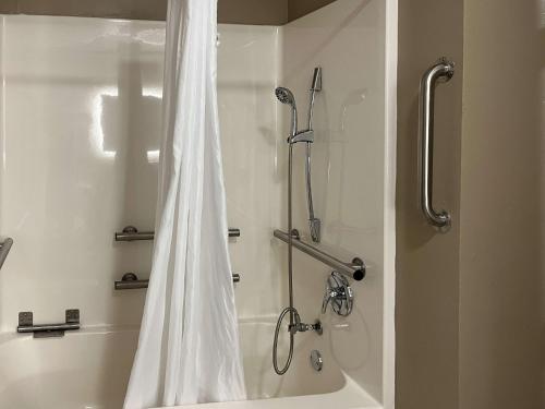 a shower with a white shower curtain in a bathroom at Motel 6 Houma, LA in Houma