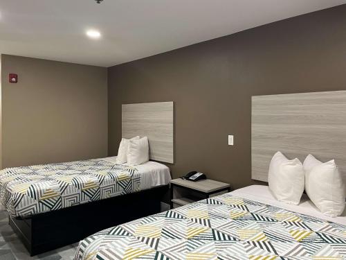 a hotel room with two beds and a phone at Motel 6 Houma, LA in Houma