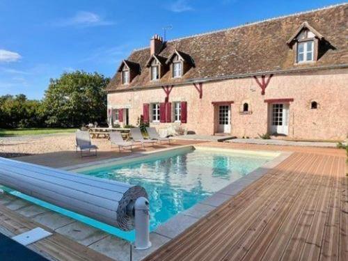 une grande piscine devant une maison dans l'établissement Gîte familial avec jacuzzi, baby-foot, fléchettes, et plus - idéal pour se ressourcer ou faire la fête ! - FR-1-491-414, à Thoré-la-Rochette
