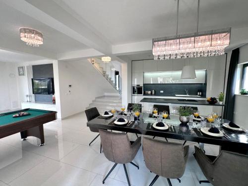 a dining room with a ping pong table in a kitchen at Fantasy Daydream Mansion in Novalja