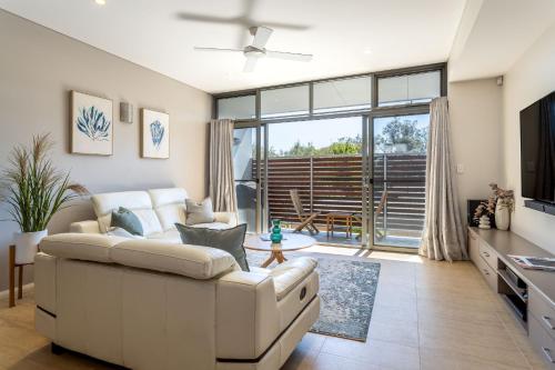 a living room with a couch and a table at Dunn Bay Apartment 5 I Private Properties in Dunsborough