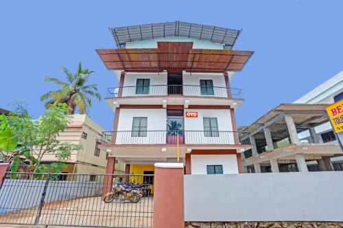 a building with a tower with a balcony at Hotel O Bevis in Trivandrum
