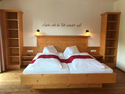 a bedroom with a bed with a wooden headboard at Hinkerhof in Schladming
