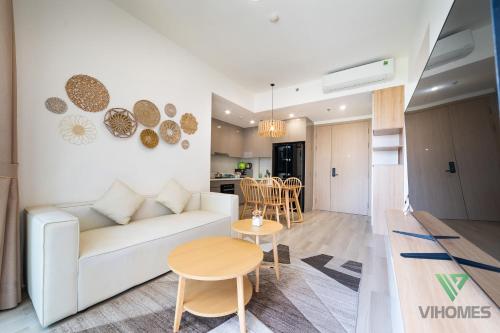 a living room with a white couch and a table at Masteri Centre Point - Vihomes serviced apartment in Long Bình