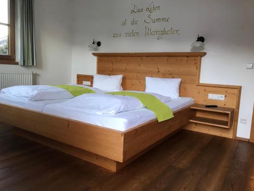 a bedroom with a wooden bed with a wooden headboard at Hinkerhof in Schladming