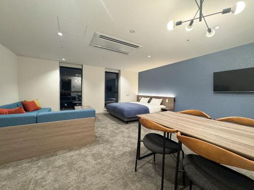 a hotel room with a bed and a table at Minn STATION Ai Nagoya in Aoichō