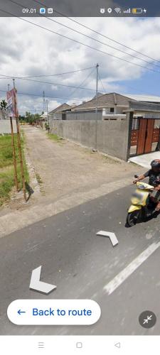 a motorcycle parked on the side of a road at Jatisela homestay in Midang