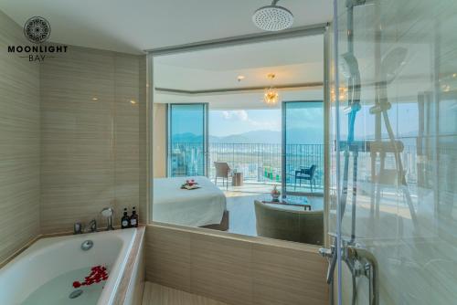 a bathroom with a tub and a view of a bedroom at Nha Trang Superview Holidays in Nha Trang