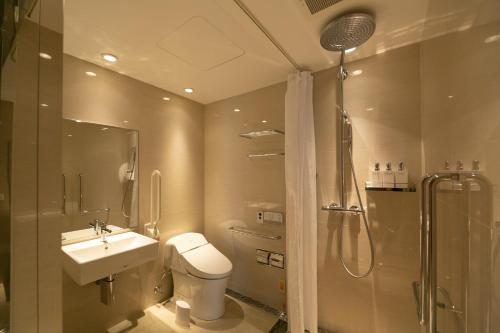 a bathroom with a toilet and a sink and a shower at THE GENERAL KYOTO Shijou Shinmachi in Kyoto