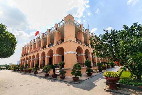 a large building with potted plants in front of it at Thiên Quốc Hotel in Ho Chi Minh City