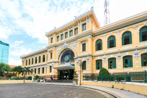 a large yellow building with a street in front of it at Thiên Quốc Hotel in Ho Chi Minh City