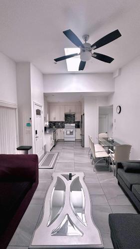 a living room with a couch and a ceiling fan at The warm and lovely coach home in Vancouver