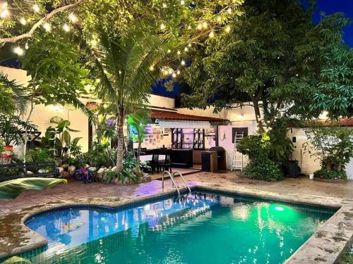 a swimming pool in a yard with trees and lights at Casa con alberca 685 in Tuxtla Gutiérrez