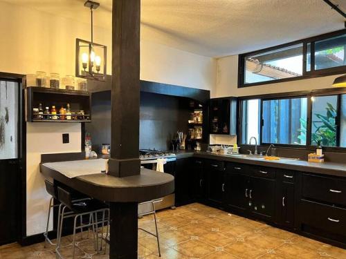 a kitchen with a stove in the middle of it at Casa con alberca 685 in Tuxtla Gutiérrez