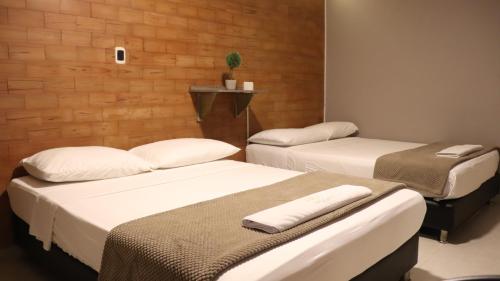 Postel nebo postele na pokoji v ubytování Hotel Simón Plaza