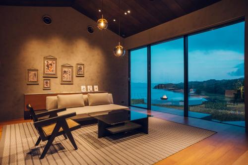 a living room with a couch and a table at Kikka Hirado in Hirado