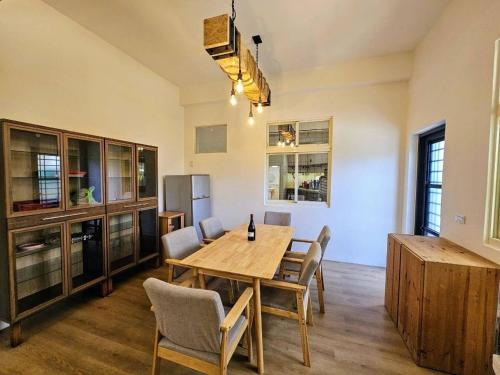 a dining room with a wooden table and chairs at Dessert No8 Homestay in Beinan