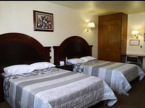 Postel nebo postele na pokoji v ubytování Hotel Novo