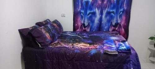 a purple bed in a room with a curtain at Holiday rooms in St Thomas Jamaica in Clifton