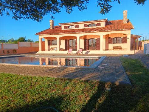 a house with a pool in front of it at CASA COM ARTE - Hospitality & Rural Impact in Vermelho